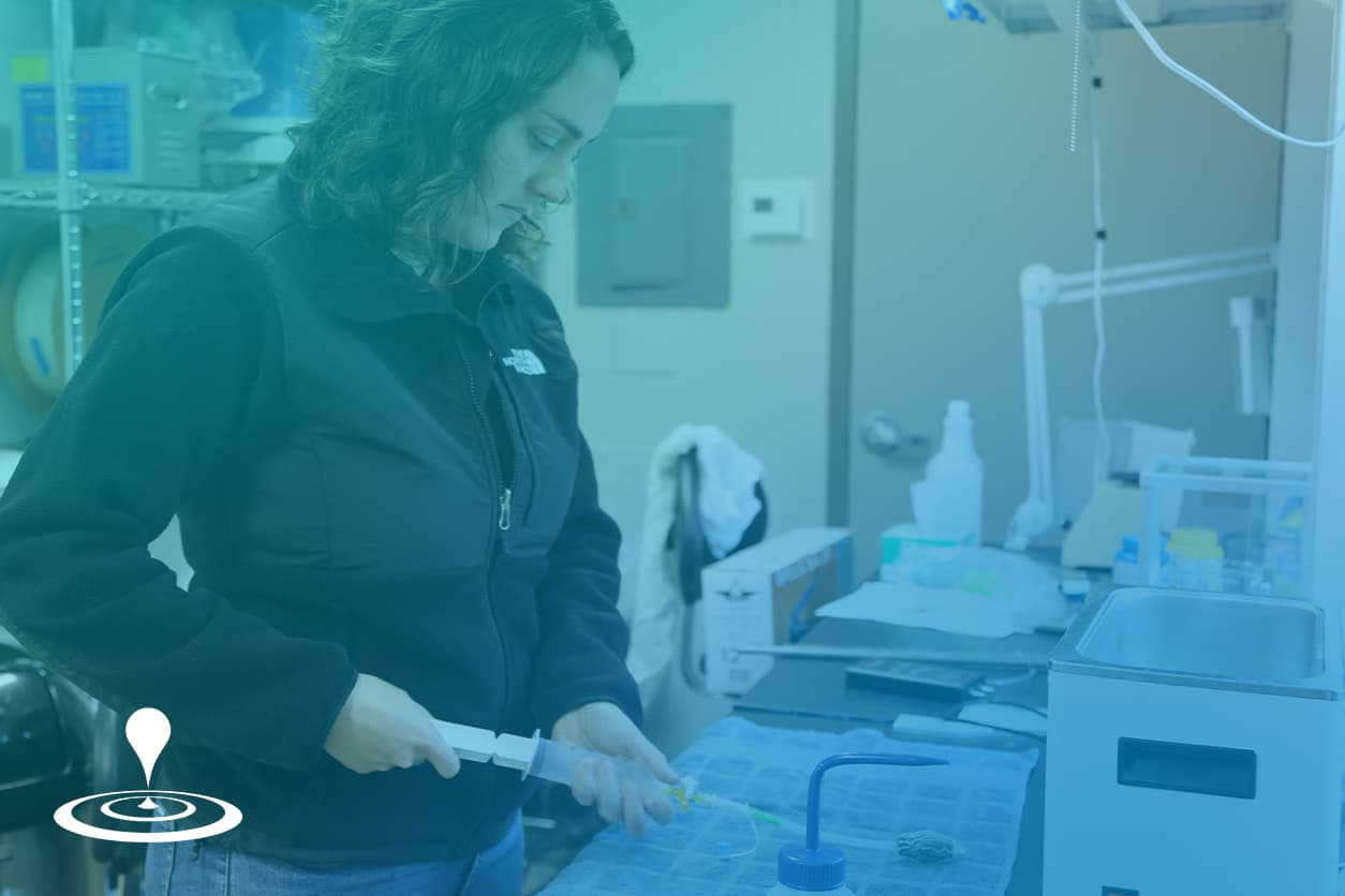 Photo of an in2being employee performing a test. in2being logomark is in the bottom left corner.